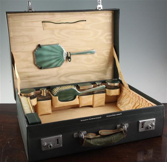 A 1930s silver and green guilloche enamel travelling toilet set by Goldsmiths and Silversmiths Co Ltd, case 18.75in.